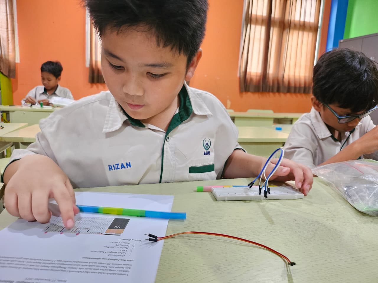 Children aged 8–12 learning coding